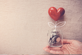 person holding a money jar